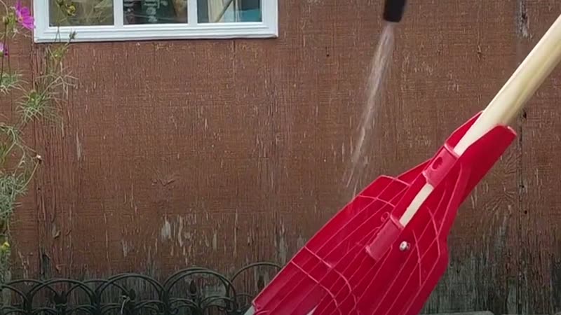 A rake being sprayed with pet-safe disinfectant